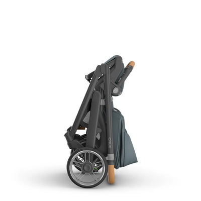 Compact, standalone fold of the Cruz stroller in the Dillan fashion.