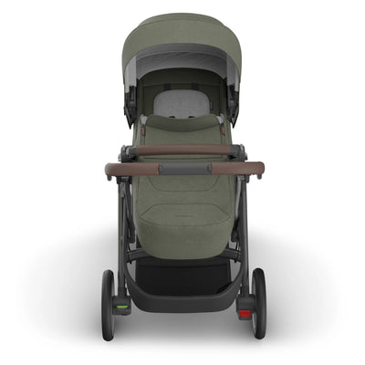 Front view of the UPPAbaby Cruz V3 stroller with the Infant Cover in Evelyn, featuring an olive green canopy and newborn-ready enclosure.