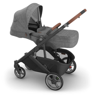 Side view of the UPPAbaby Cruz V3 stroller with the Infant Cover in Greyson, featuring a grey melange canopy and newborn-ready enclosure.