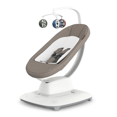 Baby swing in taupe with toys on white background.