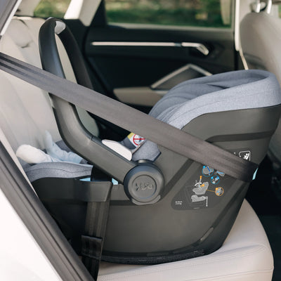 Gregory Mesa car seat secured with seatbelt in the back of a car.