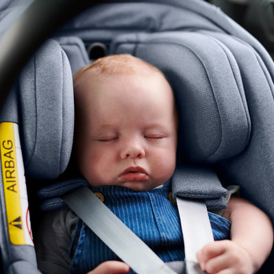 Baby sleeping in Gregory Mesa car seat in newborn mode.