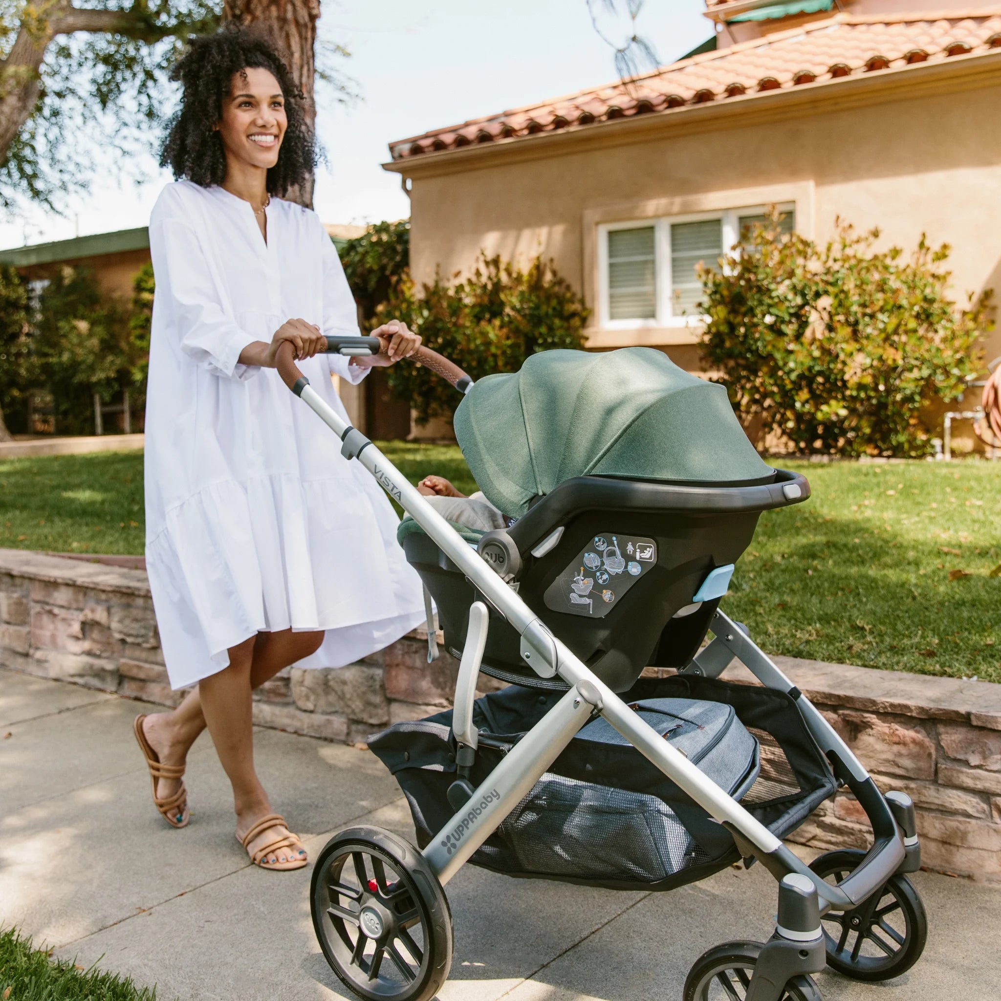 Woman pushing the Gwen Mesa on a Vista chassis using it as a travel system.