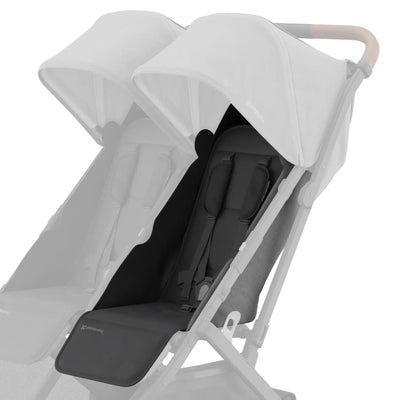 Black replacement seat fabric installed on the right side of a UPPAbaby Minu Duo double stroller frame, shown on a white background with the opposite seat faded out.