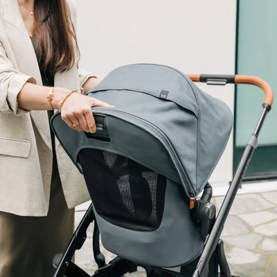 Parent adjusting the recline of the toddler seat on the Vista pram.