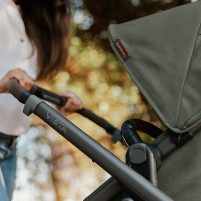 Close-up of a Vista stroller in Evelyn with a blurred natural background