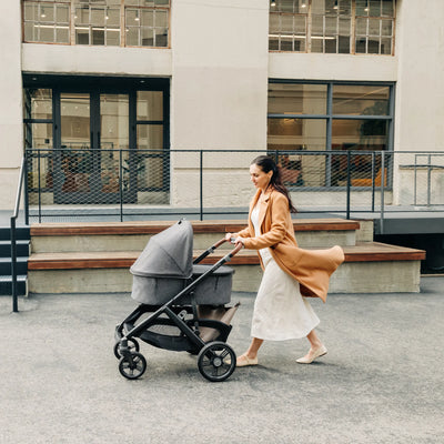 Mum pushing bassinet on Greyson Vista stroller.