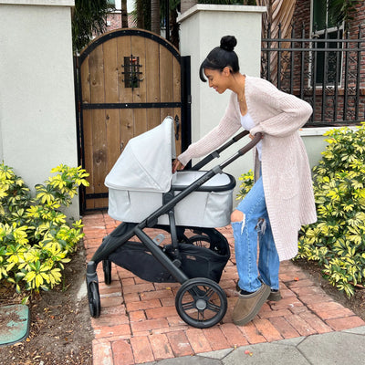 Woman tending to baby in Savannah bassinet on the Vista V3.