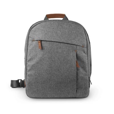 Grey UPPAbaby Changing Backpack (Greyson) with brown leather accents and top handle, shown against a white background.