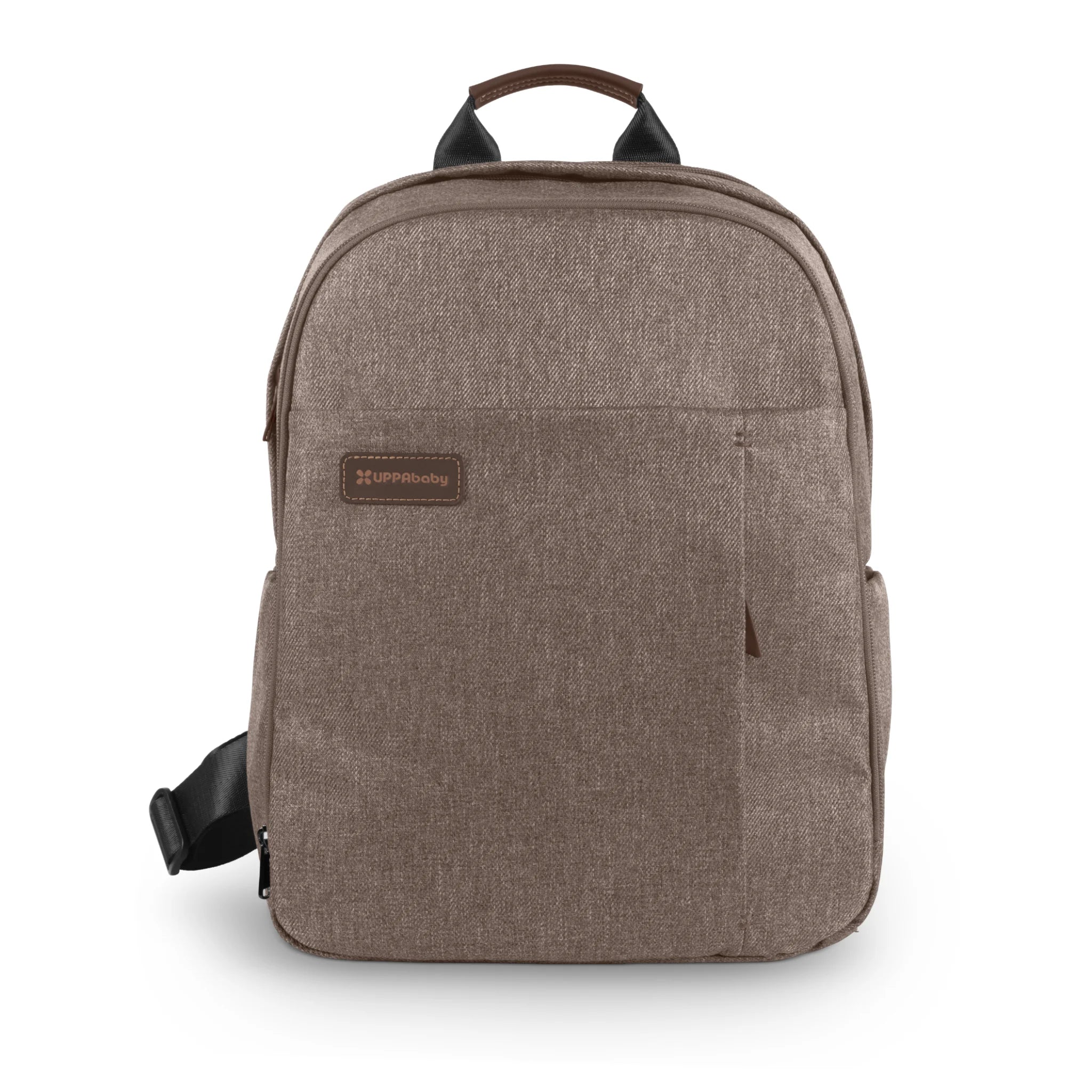 Brown UPPAbaby changing backpack shown from the front on a white background, featuring a top carry handle, front zip pocket, and visible UPPAbaby logo patch.