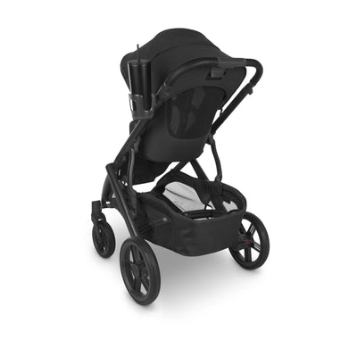 Black stroller with a cup holder attached to the handlebar holding a black tumbler, on a white background.