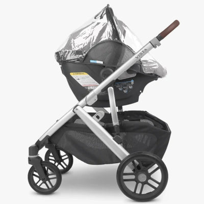 UPPAbaby Vista stroller with MESA i-SIZE infant car seat attached, fitted with a clear rain cover, shown on a white background.