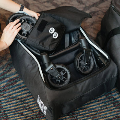 UPPAbaby Minu V3 Travel Bag with folded stroller inside, open stroller travel bag being packed