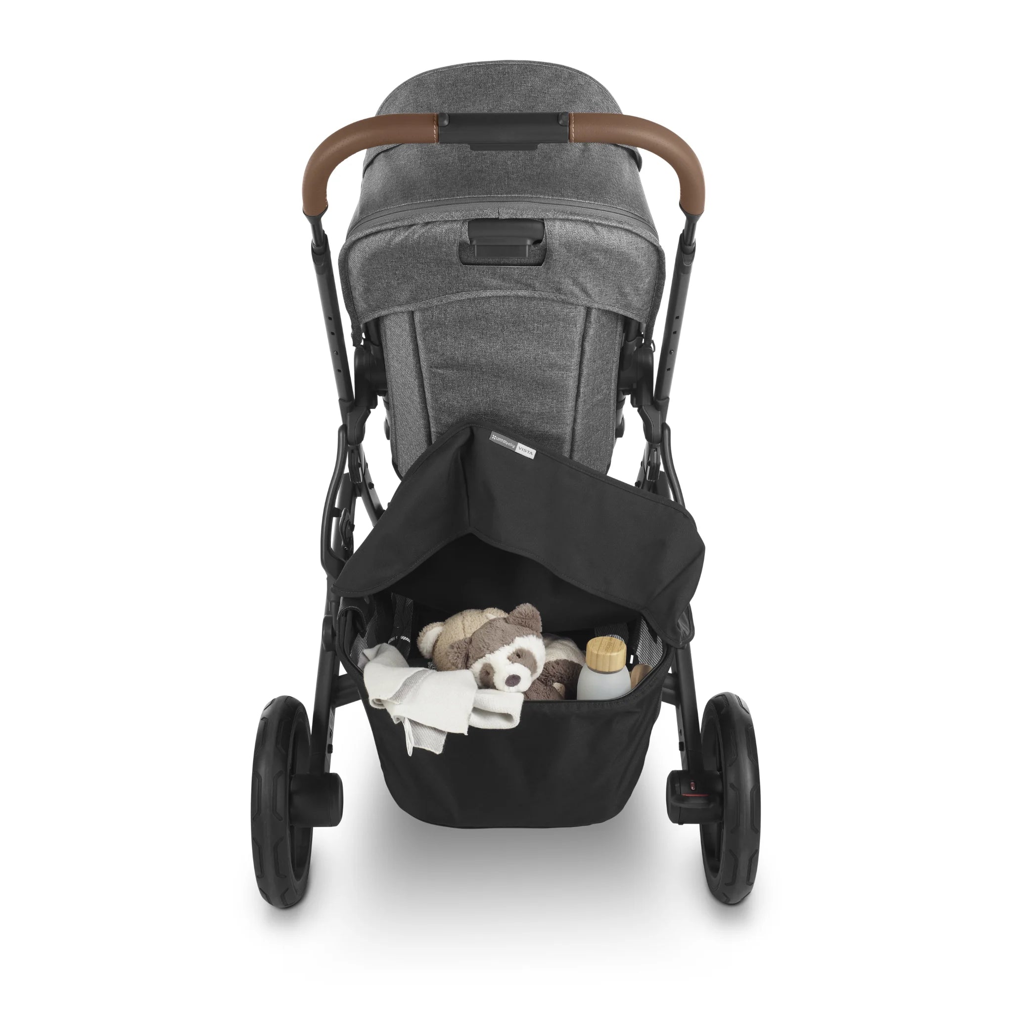 Rear view of UPPAbaby Vista stroller with basket cover open, showing underseat storage holding baby items