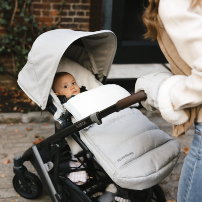 Baby looking up out of vista buggy,outside. 