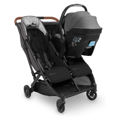 Minu duo mesa i-size adapters, in grey,on display on a buggy,with carseat, on a white background.